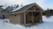 Off-the-grid wood-fired boiler room built out of timber frame and straw bale